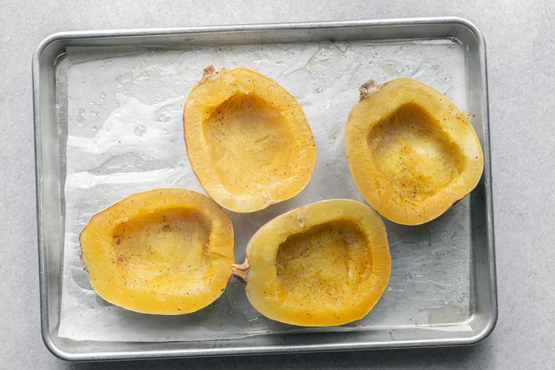 Roasted spaghetti squash on a sheet pan, face up