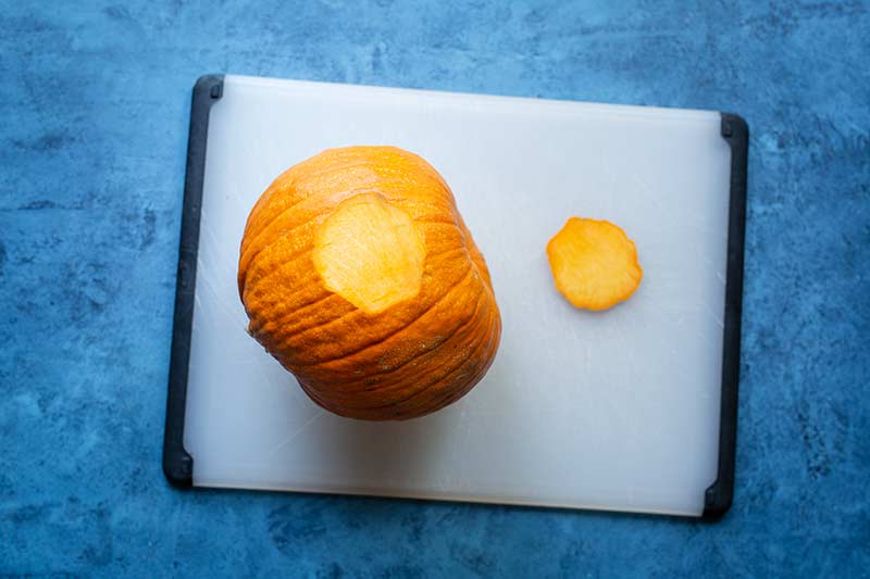 A slice of pumpkin removed to create a flat surface