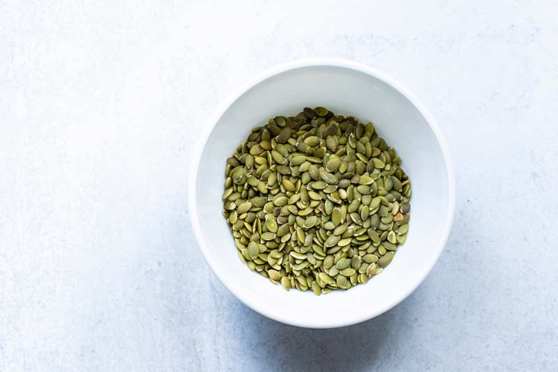 Raw pumpkin seeds in a bowl