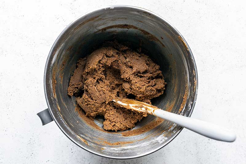 old fashioned molasses cookie dough fully mixed in a stand mixer bowl