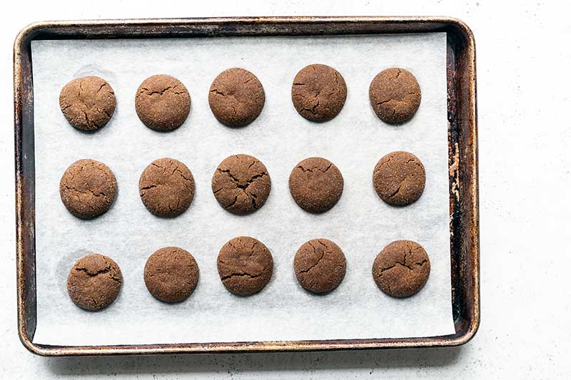 A sheet pan with soft old fashioned molasses cookies, just out of the oven