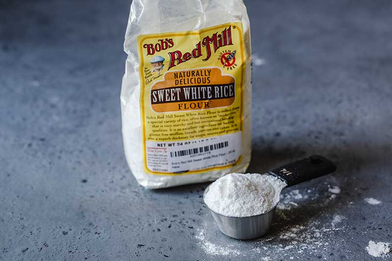 rice flour in a measuring cup next to the package