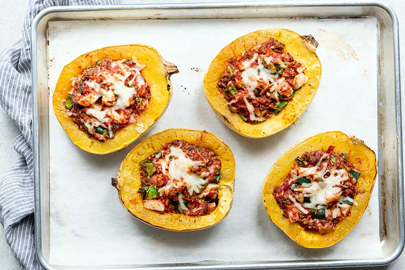 Italian sausage spaghetti squash boats just out of the oven, still on sheet pan