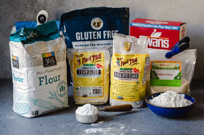 Different types of flours displayed in their bags