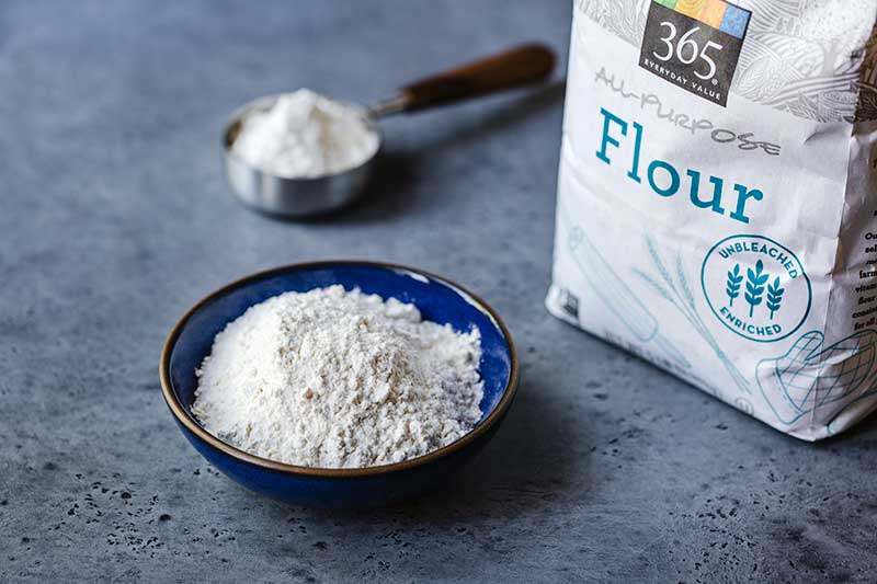 all-purpose flour in a bowl next to the package