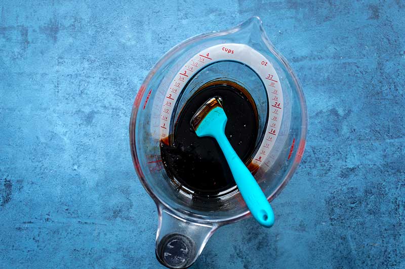 Balsamic vinegar reduction in the same liquid measuring cup to 1/2 cup line
