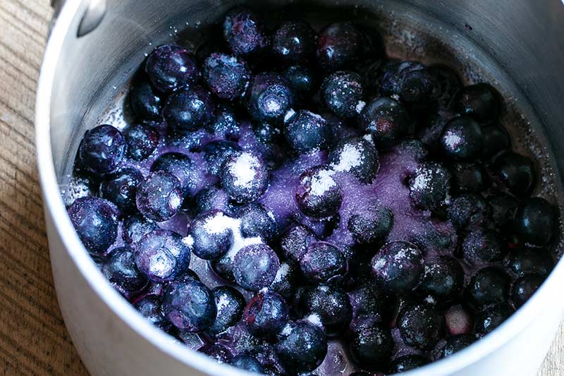 closeup of uncooked blueberry compote ingredients in saucepan