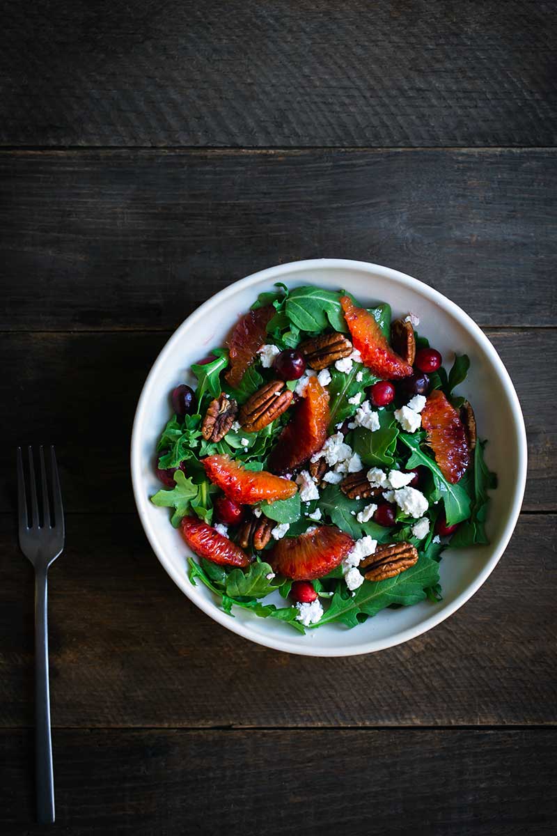 Cranberry pecan orange salad recipe in a salad bowl with a fork
