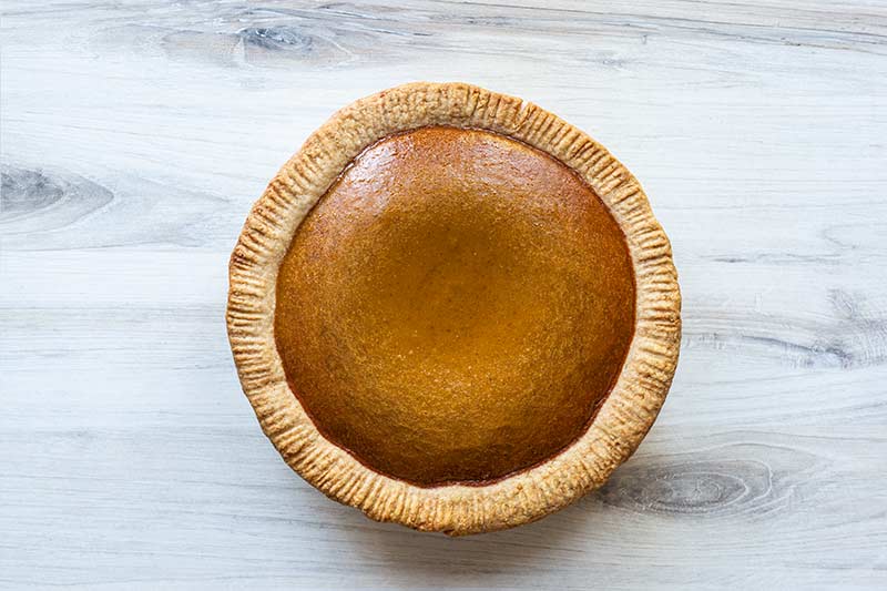 fresh pumpkin pie right out of the oven, still slightly puffed up.