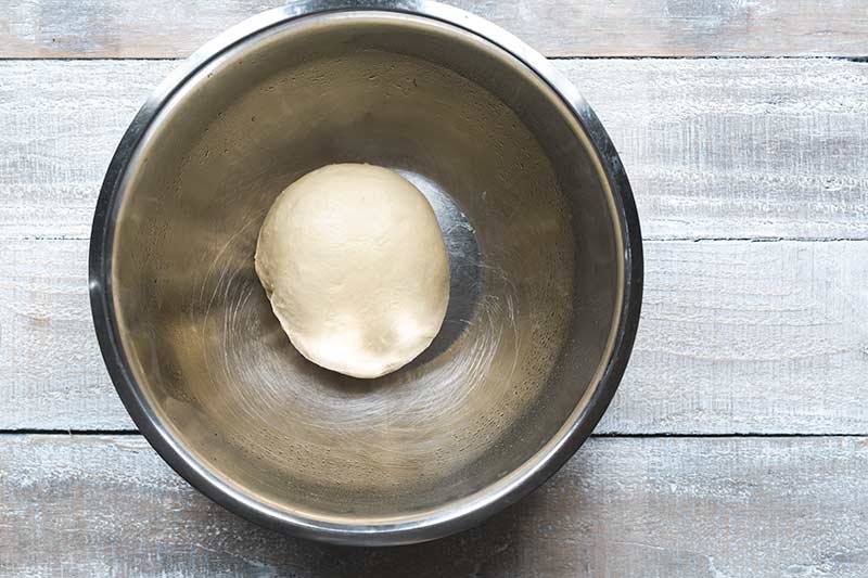 Bread dough in an oiled bowl.