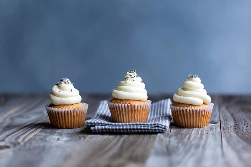 Three London Fog Cupcakes spread out in a row.