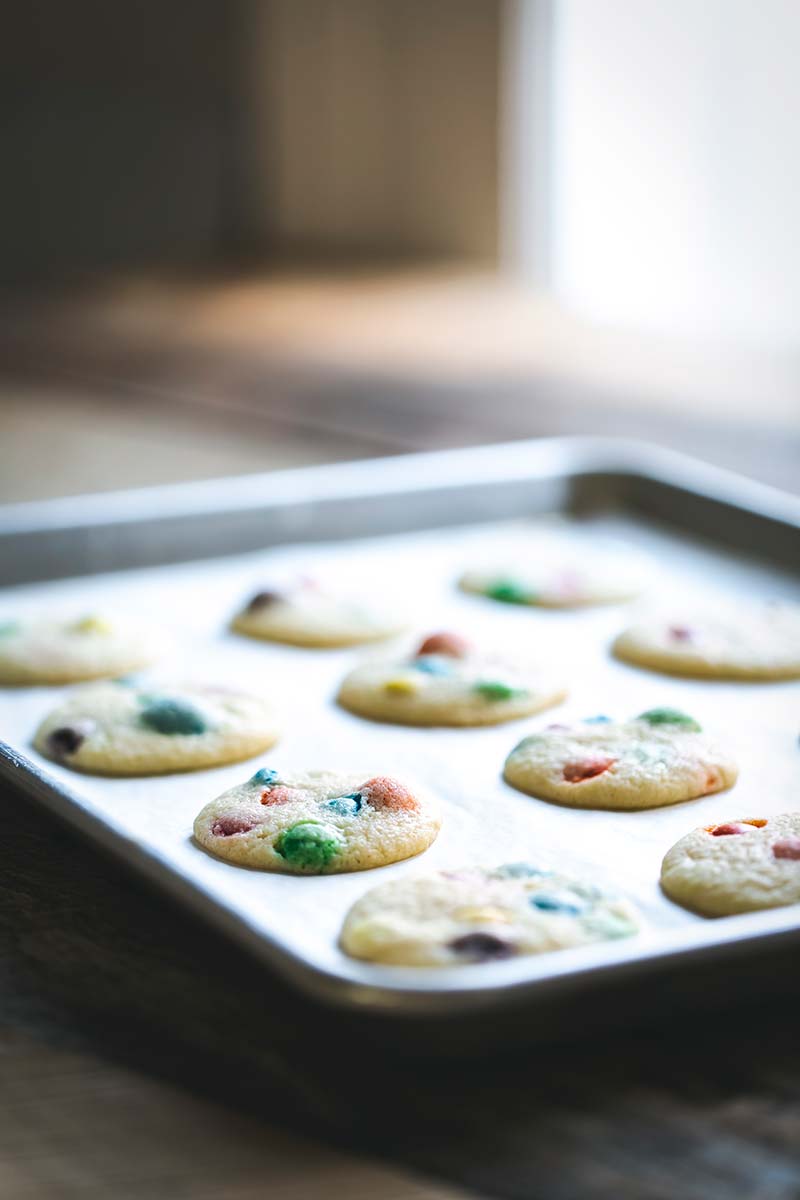 M&M Cookies on a sheet pan, set on an angle