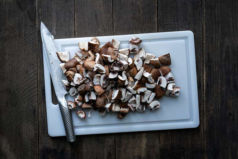 Chopped mushrooms on a cutting board.