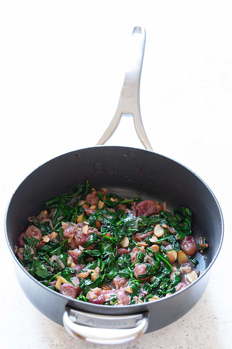 The grapes added back to the pan so all the ingredients for the recipe are in the skillet.