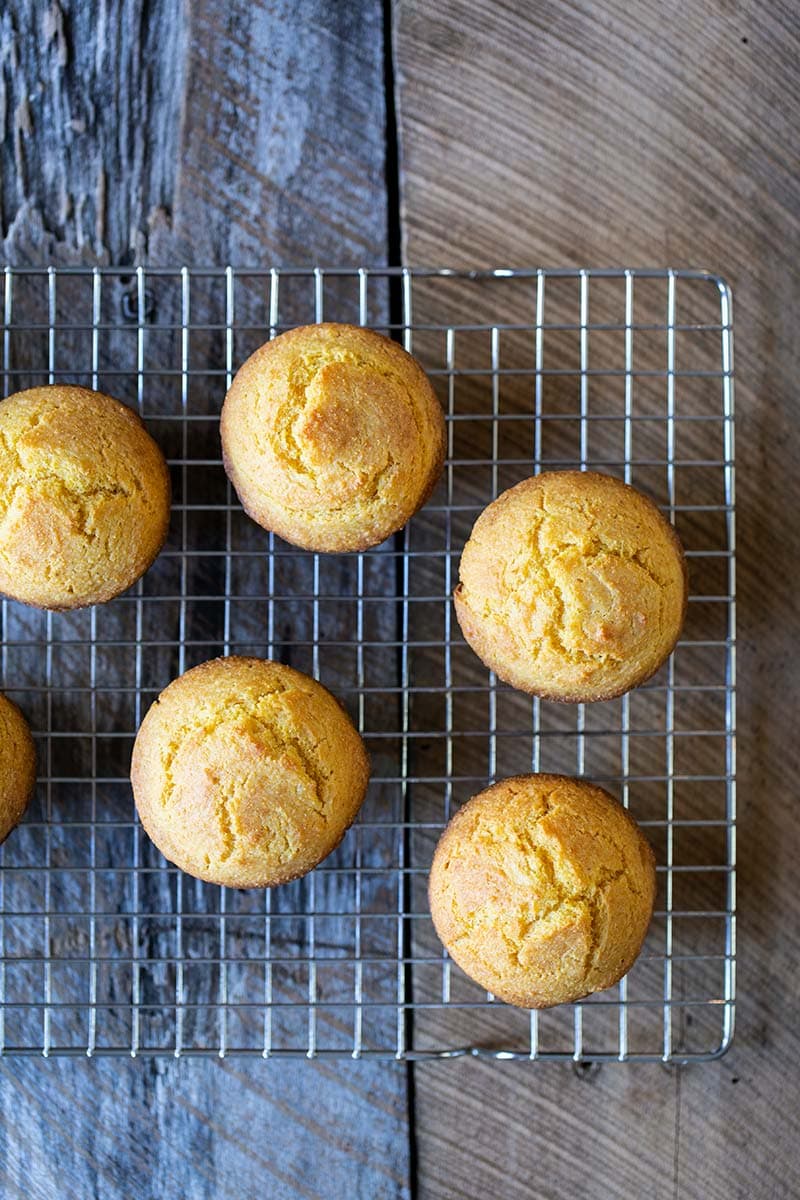 Homemade corn muffin recipe on a cooling rack