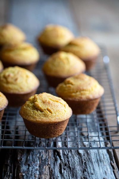 Homemade corn muffins on a cooling rack