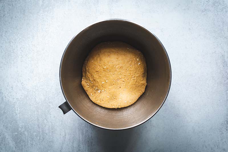 Bread dough in the bowl of a stand mixer after it has doubled in size