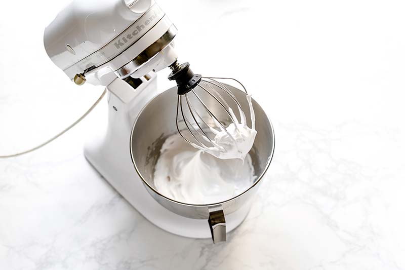 Egg whites whipped to a stiff peak in a stand mixer