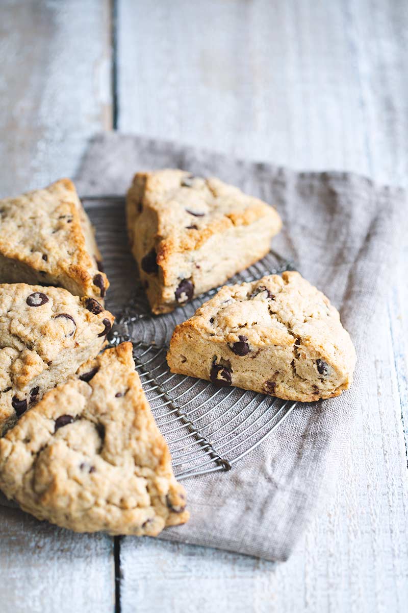 Chocolate chip scones on a round cooling rack and napkin