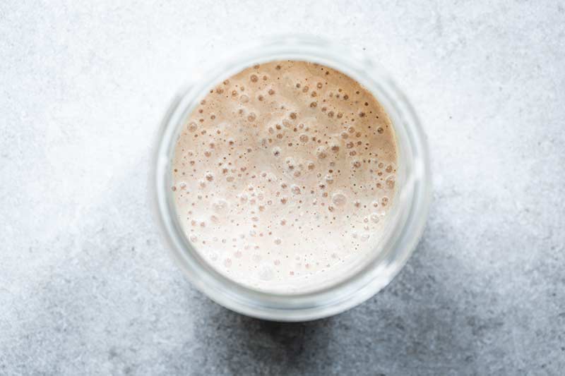 Overhead shot of hungry sourdough starter with lots of bubbles