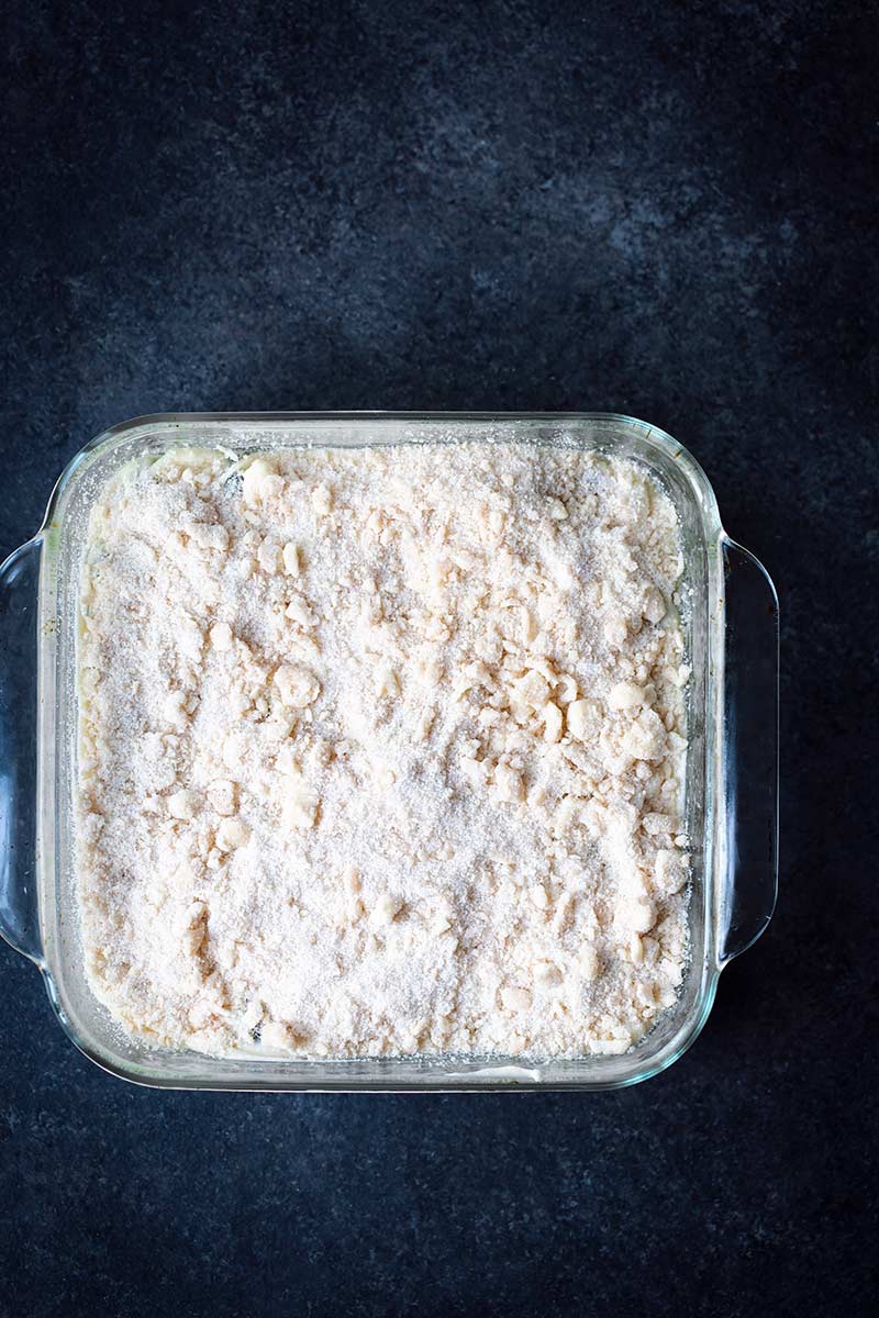 Topping sprinkled over blueberry cake filling