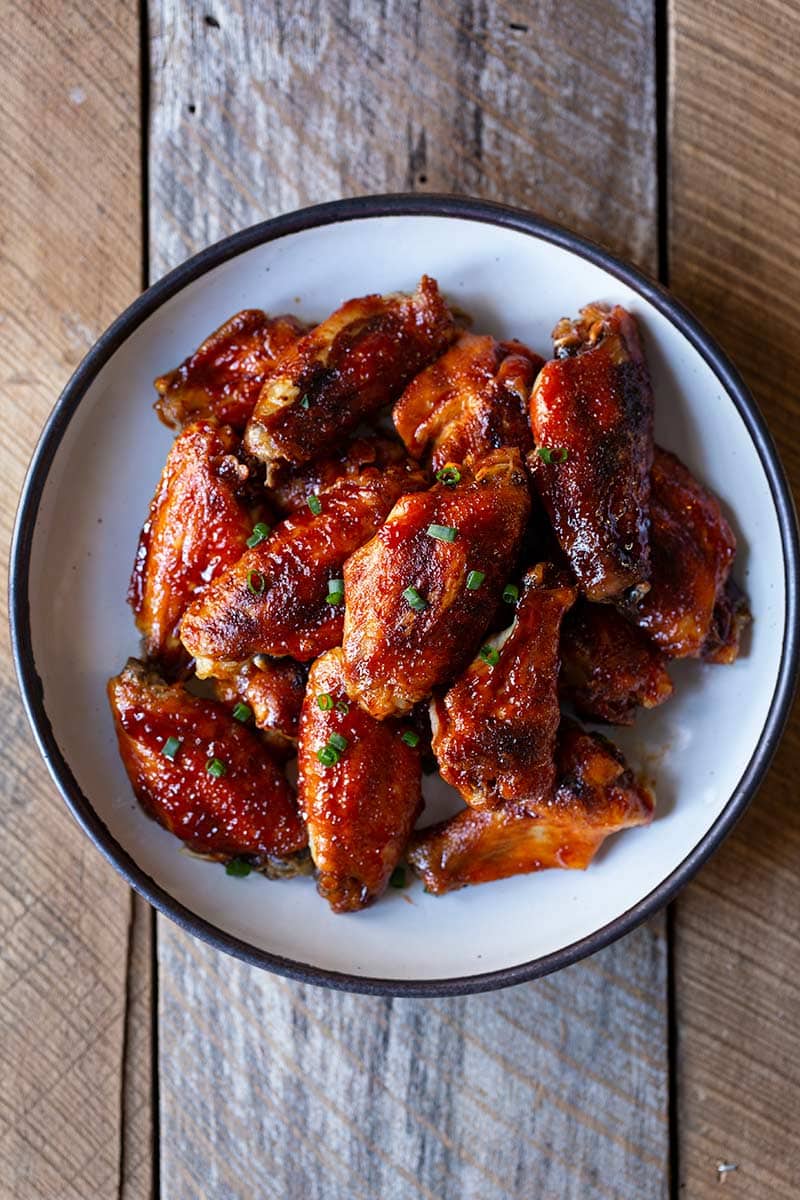 Gochujang wings in a bowl shot from overhead.