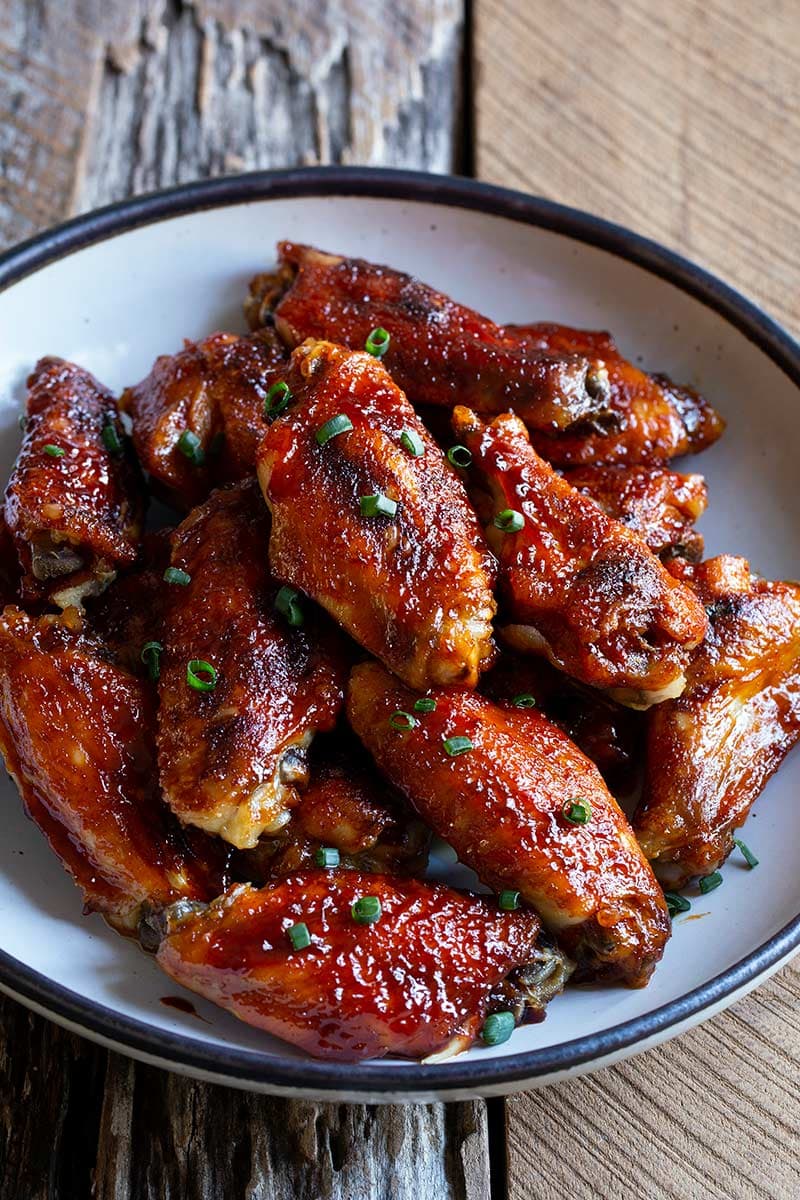 Close up of Korean chicken wings in a bowl.