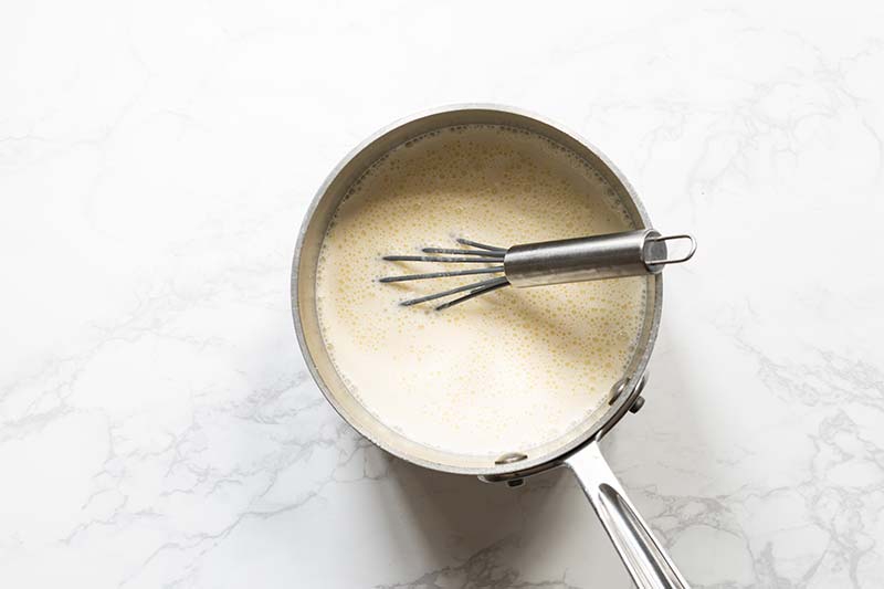 Cream and milk whisked into egg yolk mixture