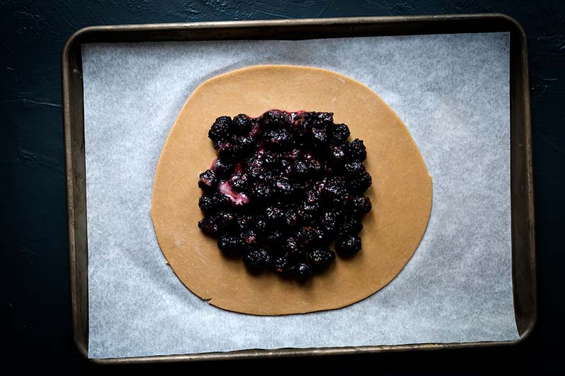 Filling for galette spread into the center of the raw tart dough