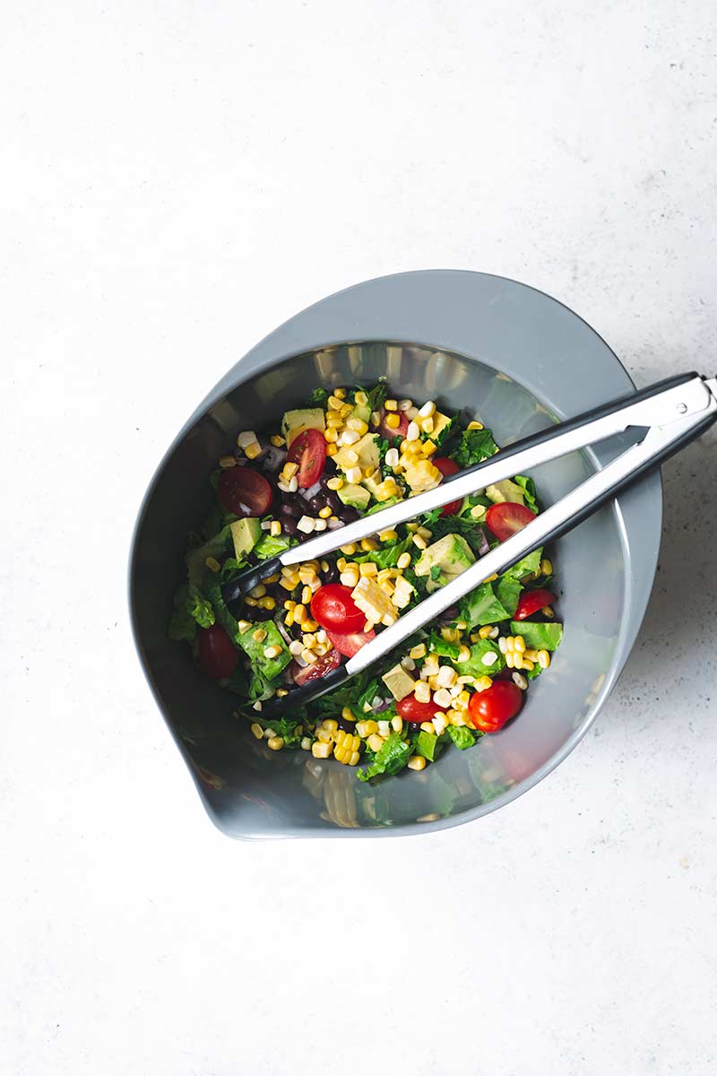 edients for salad in a bowl with tongs