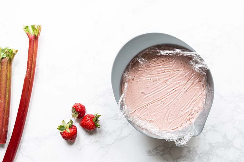 Plastic wrap pressed directly against base to prevent a skin from forming