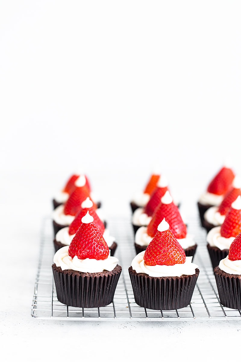 9 Santa Hat Cupcakes on a cooling rack